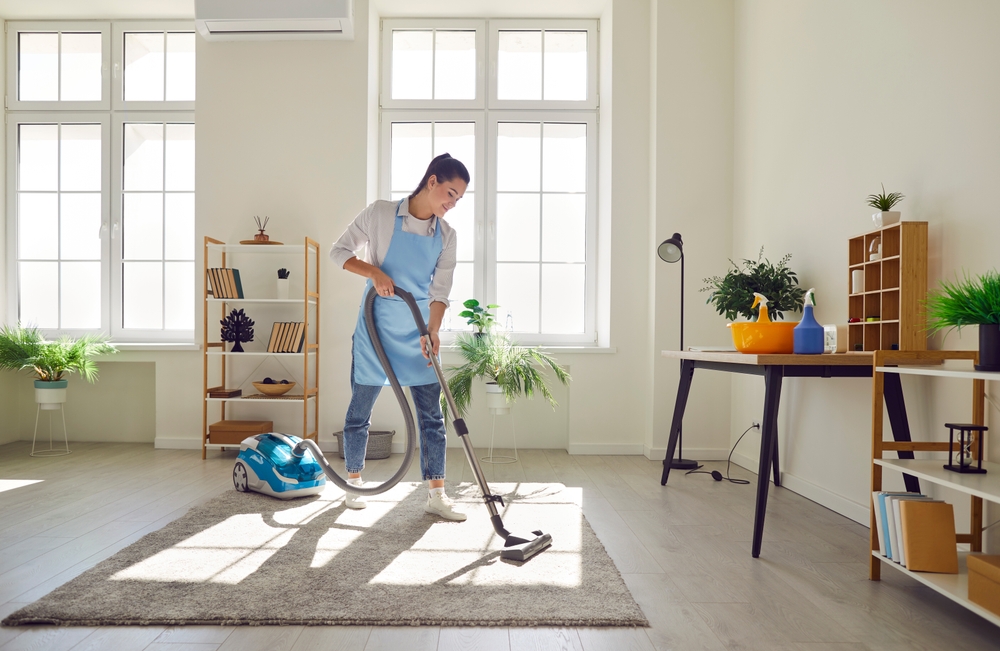 Professional cleaner performing detailed deep cleaning service in modern kitchen in Newburyport MA